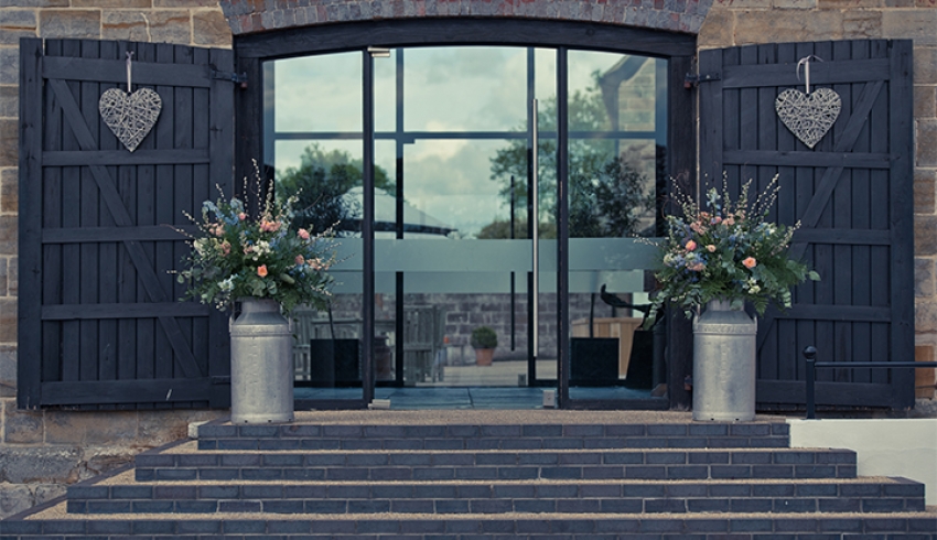 The beautiful front glassed entrance into Hendall Manor Barns, a Sussex wedding venue